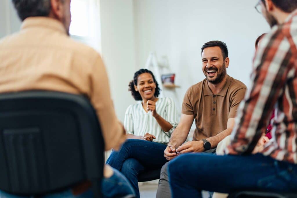 Coed group therapy session during addiction treatment in Massachusetts.