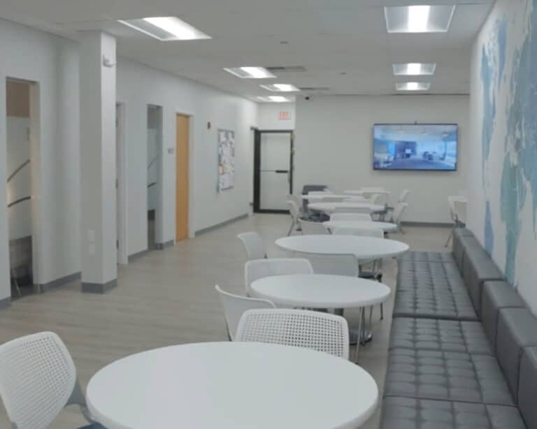 Open common area at Rockland Recovery Treatment Center with round tables and seating