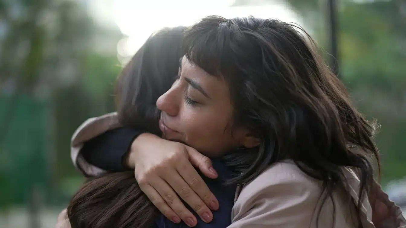 a woman hugging another woman showing support for her addiction recovery