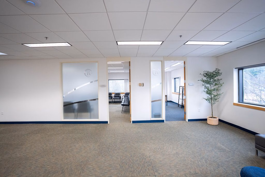 A common area with windows along one wall at Rockland Recovery Behavioral Health North in Bedford, Massachusetts.